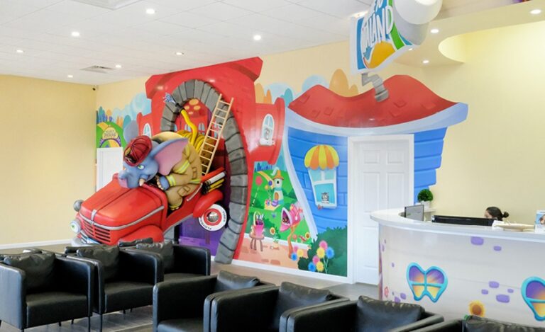 3D elephant bursting through the wall on a firetruck in a patient waiting room.