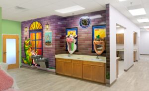 brushing station in a pediatric office decorated with sculpted animal mirrors and themed murals