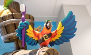 Colorful parrot holding a toothbrush sculpted on top of a ship's mast in a pediatric dental practice