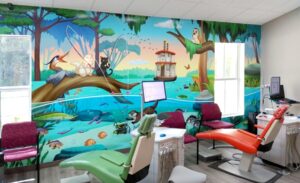 Dental treatment open bay fitted with an anxiety-relieving mural of a wetland river featuring the dentist's cats