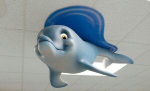 Smiling sculpted dolphin ceiling character with an acrylic waterline