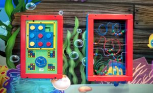 Kee Bee wall-mounted game units in themed waiting room for kids