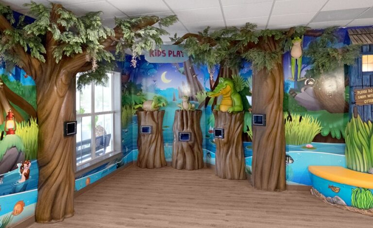 Kids game area themed with calming nighttime bayou murals and gaming tablets