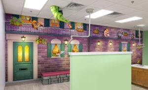 open treatment bay themed with musical mardi gras murals and a sculpted smiling crocodile in a ceiling tile
