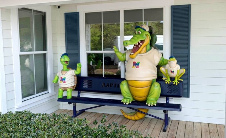 Outdoor bench for a dental clinic featuring sculpted photo op animal mascots