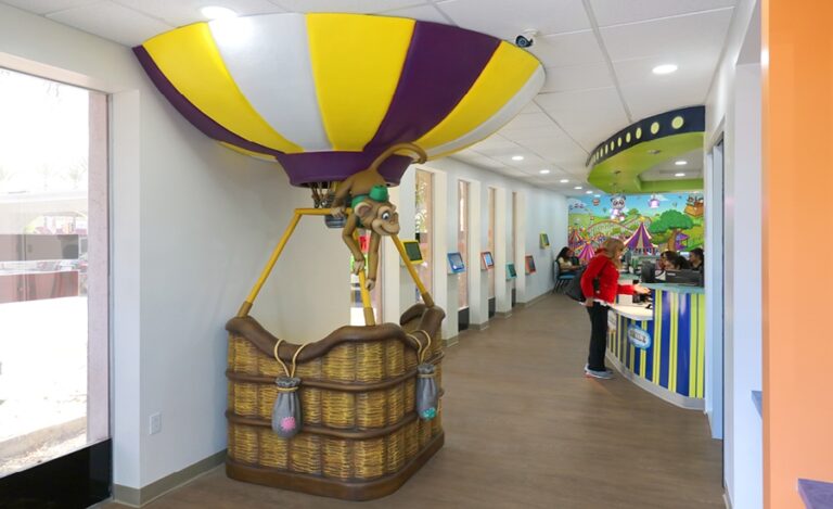 Pediatric dental reception area with circus theme and hot air balloon and monkey photo op