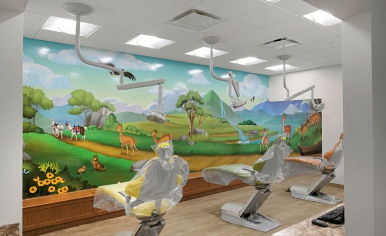 Pediatric treatment bay with wall mural featuring illustrated South American landscapes and native animals