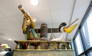 sculpted pirate monkey and pelican looking out from a ship mast in a children's playroom