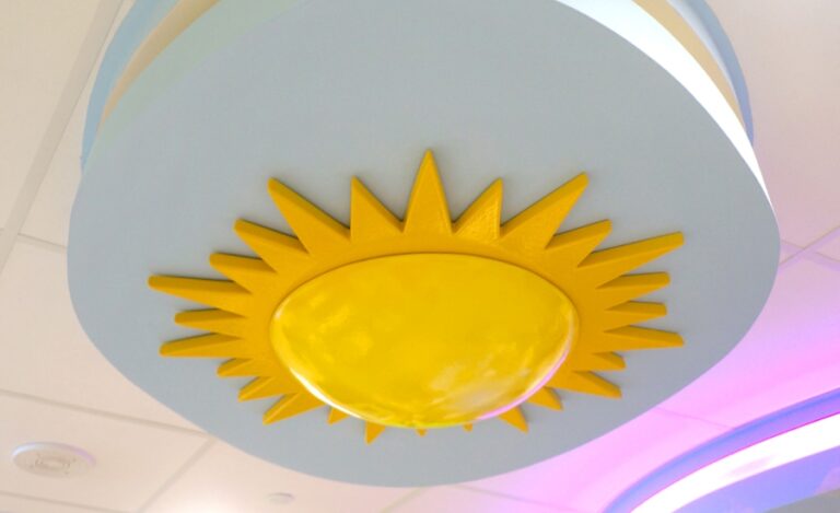 Sculpted stylized sun in a hospital waiting room ceiling