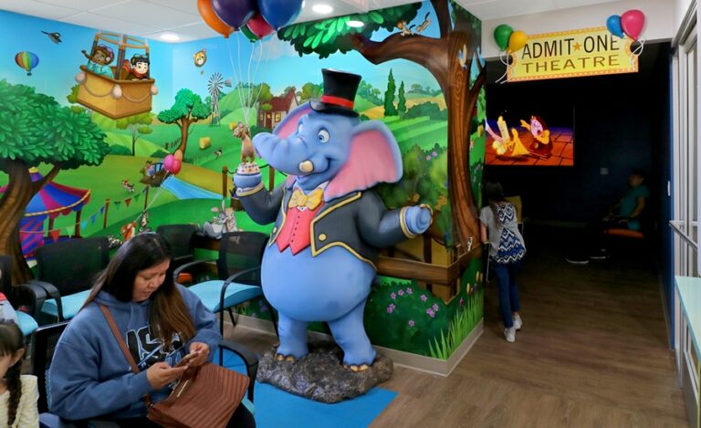 Waiting area with carnival murals and ring master elephant sculpture for kids