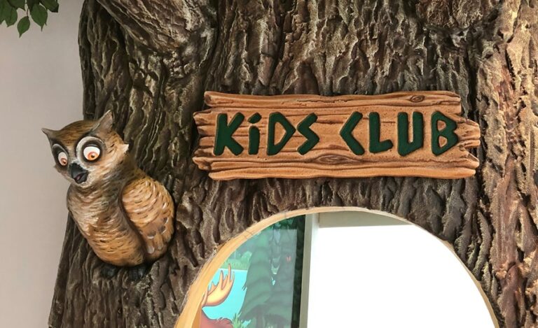 close up of 3d kids club sign with recessed letters and owl character