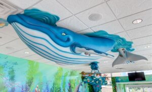 close up of ceiling whale sculpture in pediatric waiting room