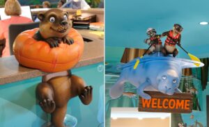 close-up of otter character on desk and rafting sculpture hanging above reception desk