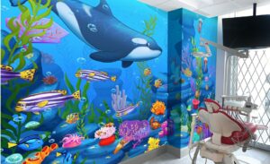 Colorful underwater wall murals in dental treatment room for kids