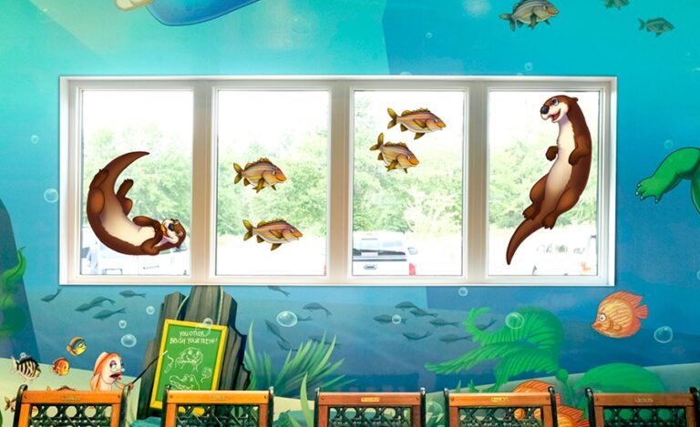 custom murals and window decals of otter characters in kid friendly dental office