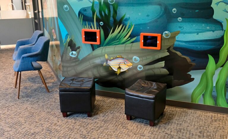 Custom river murals and wall mounted gaming units in pediatric dental office