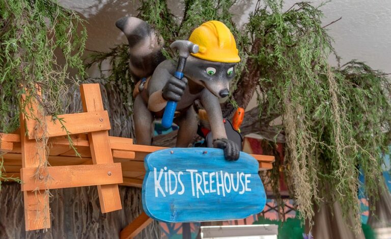 cute raccoon construction worker character in kids play area