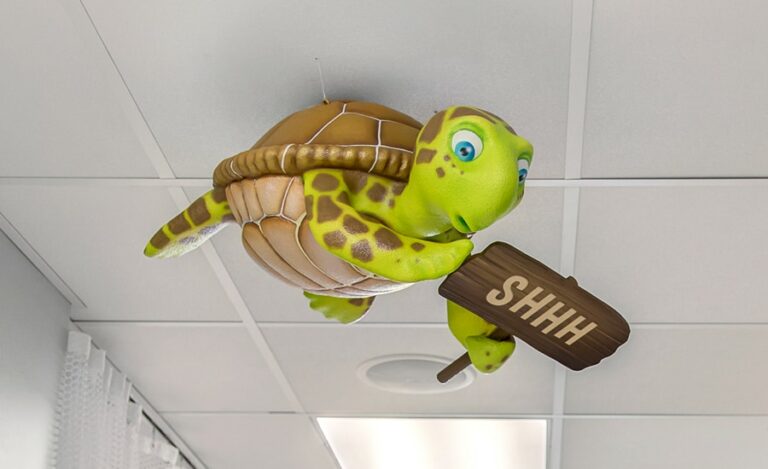 cute turtle character with shhh sign