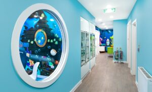hallway with porthole window showing ocean mural within