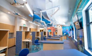 kid-friendly open treatment bay with underwater theme in pediatric dentist office