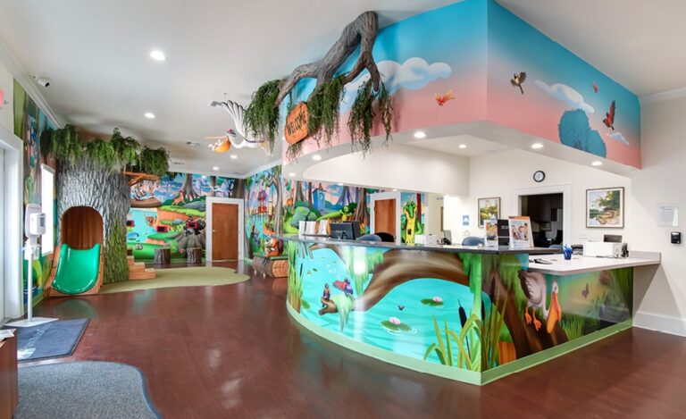 pediatric waiting room with bayou murals and play area in medical office