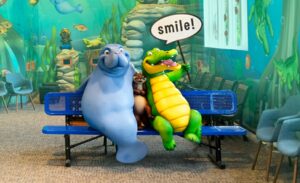 Photo op bench in kids dental office featuring crocodile, manatee, and otter characters