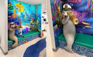 photo op corner with a sculpted seal character and custom murals and bench in pediatric dental office