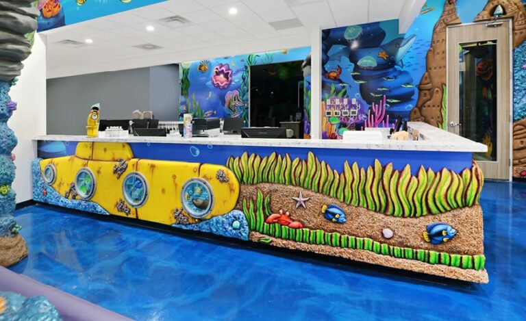 Reception desk cladding featuring a yellow submarine and kelp forest with fish swimming through