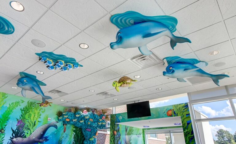 sculpted dolphin, fish, and turtle characters in waiting room