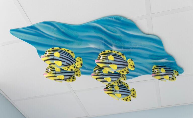 striped fish sculptures suspended from ceiling