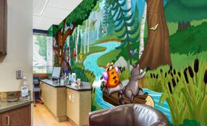 Treatment area with woodland wall murals in pediatric clinic