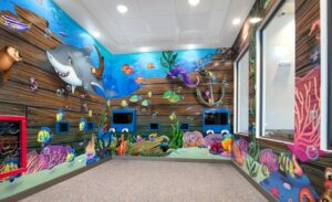underwater murals in themed play area for kids with gaming units