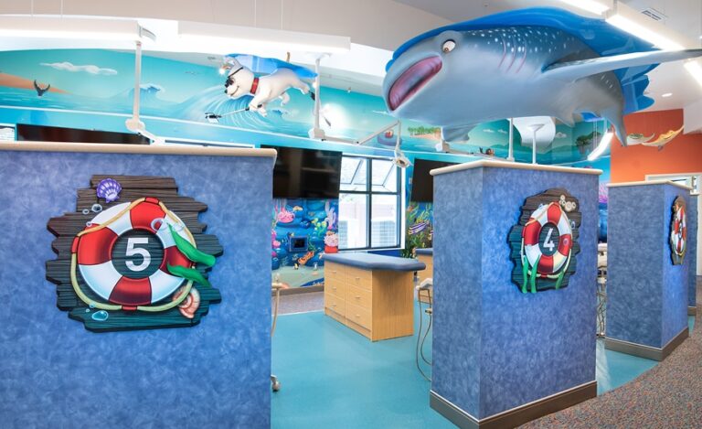 underwater themed murals and sculptures in treatment area of kids dental office