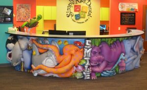 jungle and marine themed reception desk with squished animal characters