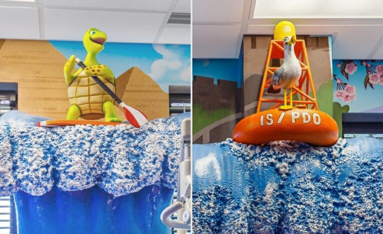 paddleboarding turtle and seagull on a buoy atop sculpted waves decorating an adventure themed office
