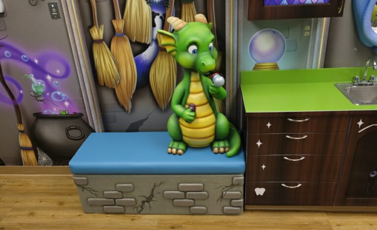 baby dragon character on bench at kids brushing station