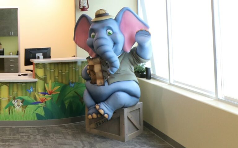 Safari elephant photo op character in a dental office reception area.