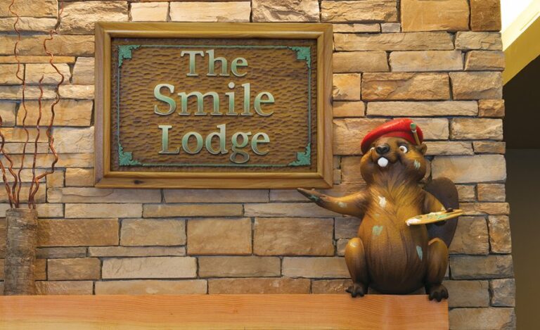 close up of lodge signage with sculpted artistic beaver character