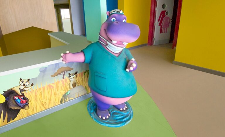 closeup of sculpted hippo character dressed as doctor in pediatric clinic