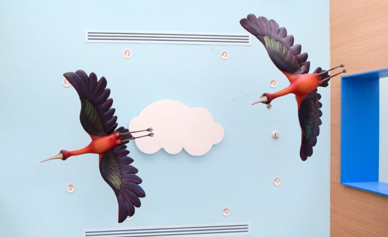 colorful bird ceiling sculptures in pediatric medical clinic