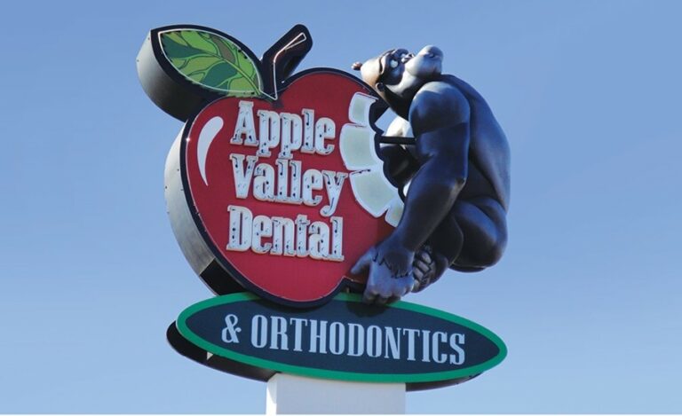 custom apple shaped dental office sign with sculpted gorilla