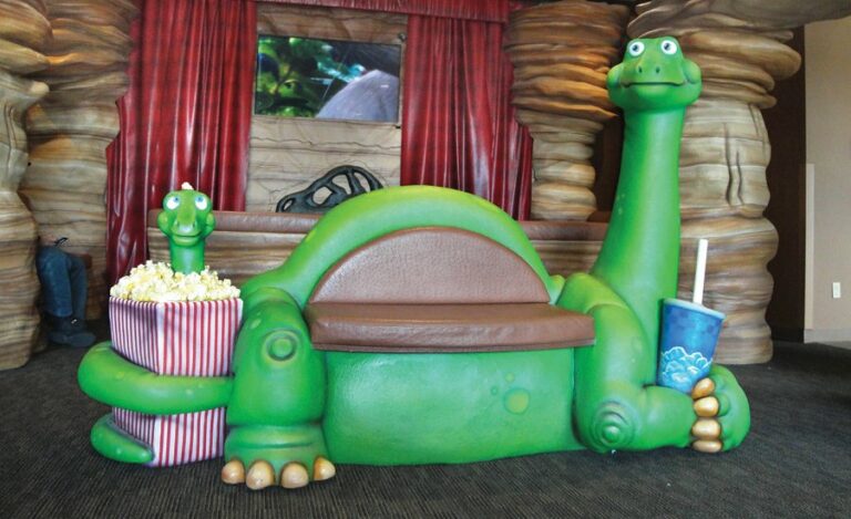 custom sculpted dinosaur couch in kids theater area