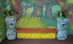custom jungle themed bench with bamboo rocks and sugar bugs with built in game holders
