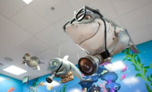 custom shark sculpture with camera and sunglasses in pediatric dental treatment room