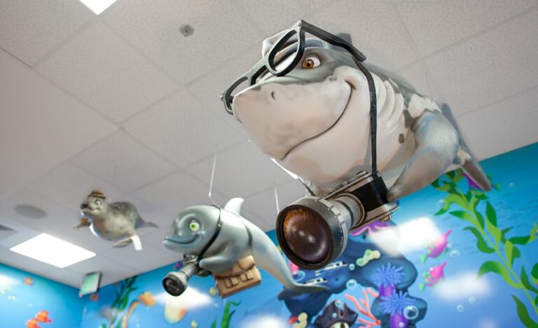 custom shark sculpture with camera and sunglasses in pediatric dental treatment room