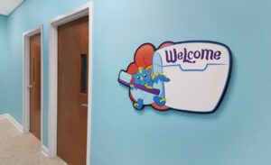 custom whiteboard sign with dragon character in pediatric office