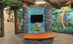 dinosaur themed theatre room with 2D to 3D dinosaur sculptures and custom made seating