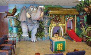 elephant character and tiki play slide in kids waiting room