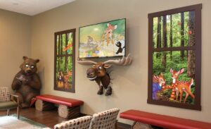 faux windows of forest terrain with friendly bear photo op and bust out moose sculpture in a themed waiting room