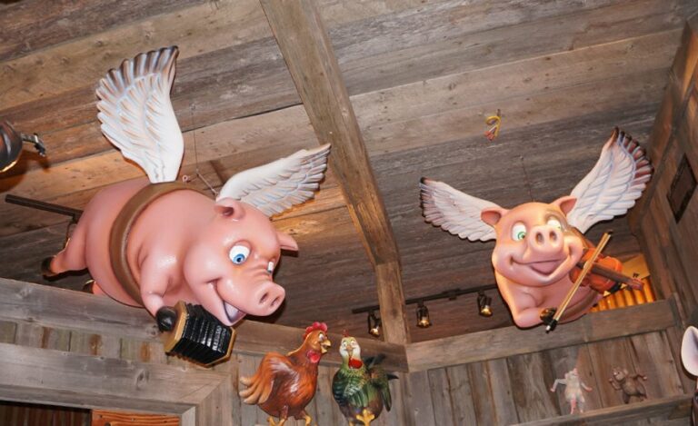 flying pig sculptures hanging from the ceiling